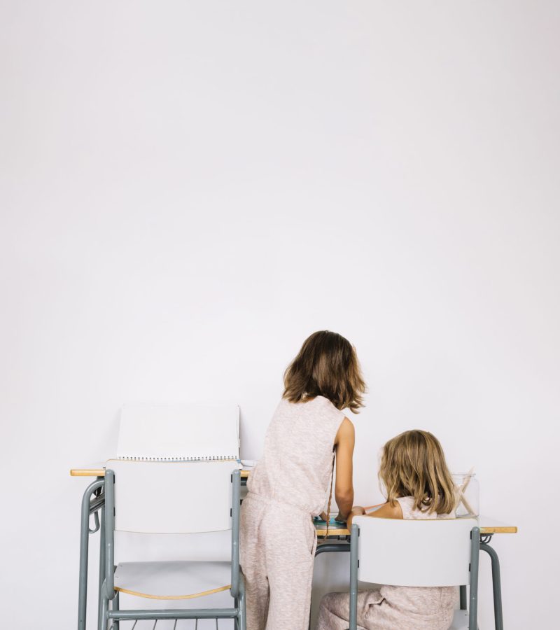 girl-helping-sister-with-homework